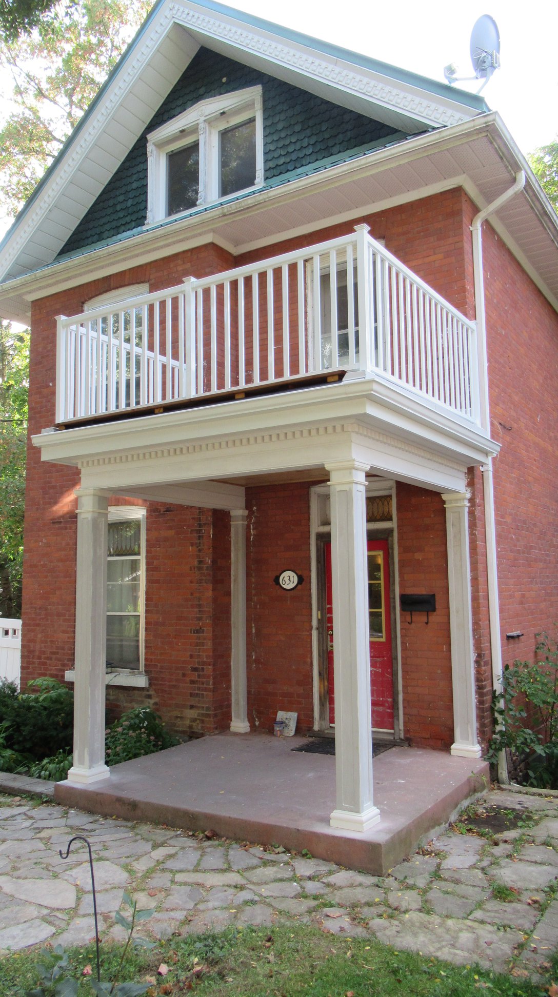 Front porch with columns and patio above